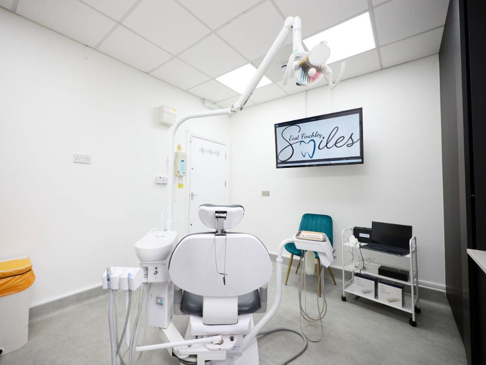 A treatment room with the practice wordmark on the wall